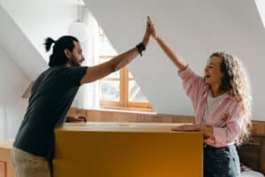 Couple High Fiving Over Successful Packing